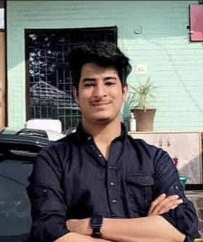 Young Indian man with glowing skin, smiling confidently